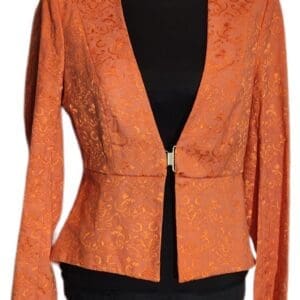 Orange blazer with floral pattern and long sleeves, worn over a black top on a mannequin.