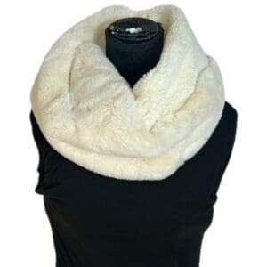 Baggy Tie Waist cream-colored faux fur infinity scarf showcased on a black mannequin torso.