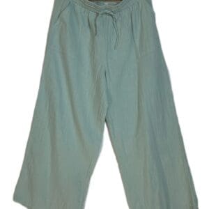 The Wide Lg Krinkly Tie Waist features light blue, wide-leg pants with an elastic waistband and drawstring, shown on a wooden hanger against a white background.