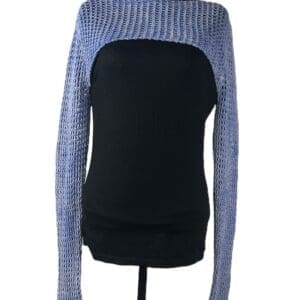 A mannequin dressed in a black top with a light blue knitted shrug featuring long sleeves and an open front.