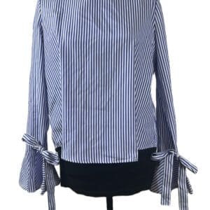 Long-sleeve blouse with blue and white vertical stripes, featuring bow ties at the cuffs, displayed on a mannequin.