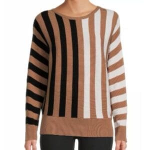 Person wearing a long-sleeve sweater with vertical and diagonal stripes in black, white, and brown, paired with black pants.