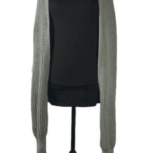 A mannequin displays a long, light gray knitted scarf draped over its shoulders, set against a plain white background.