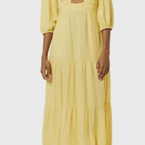A woman wearing a Yellow Long Half Puff Sleeve Dress with a v-neckline, tiered midi silhouette, and front cutout detail, paired with white platform sandals.