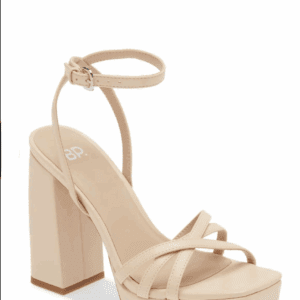 Beige high-heeled sandal with a thick block heel, platform sole, crisscross front straps, and an adjustable ankle strap with a buckle.