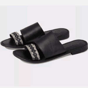 A pair of black open-toe flat sandals with wide straps and a decorative zigzag pattern on the front strap.