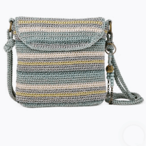 A crocheted crossbody bag with horizontal pastel stripes in blue, yellow, and beige, featuring a flap closure and a beaded accent on the strap.