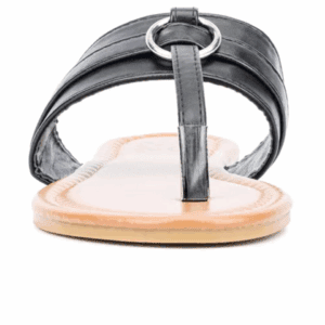 A front view of a black leather thong sandal with a metal ring detail and a flat beige sole.