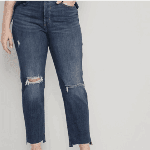 Model wearing Extra High-Rise Sky-HI Straight Ripped Jeans in a dark wash with ripped knees and frayed hems, posed against a plain light background.