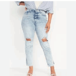 Person wearing High-Rise Curvy O.G. Straight Ripped Jeans with frayed hems, a tucked-in striped shirt, and white heeled sandals.