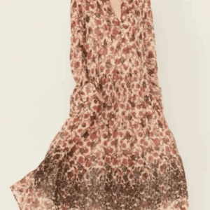 A woman in a Long, Long Sleeve Sheer Flowered Dress featuring a loose fit and floral pattern that darkens toward the ankle-length hem.