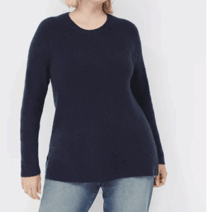 A person models the Sweater—featuring long sleeves and a dark navy color—with blue jeans, standing against a plain white background.