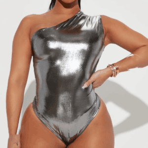 Model showcases the One Shoulder Bodysuit in shiny metallic silver, posing with one hand on their hip against a plain background.