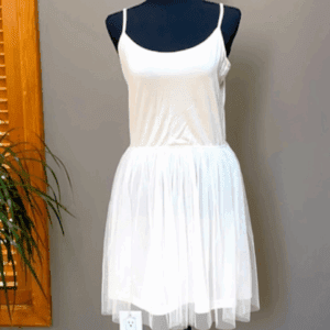The Spaghetti Strap Sheer Layered Casual Dress, featuring a sleeveless white design with a tulle skirt, is displayed on a black dress form against a gray wall.