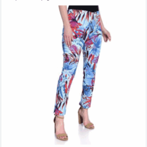 A woman wears a Red Ruffle Wrist & Neck Blouse with Blign Rose, styled with high-waisted, slim-fit blue and red tropical floral pants and beige heeled sandals.