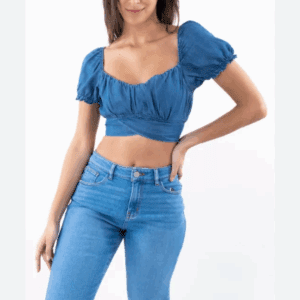 A woman poses against a plain white background wearing Sheer Cover Up Pants and a blue puff-sleeve crop top.