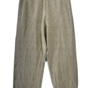The Sheer Cover Up Pants, featuring a loose fit and elastic waistband, hang from black clips against a white background.