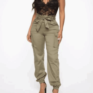 Woman dressed in the Lace Spaghetti Top Jogger Jumper, featuring a black lace camisole and high-waisted olive green cargo pants with a tied waist, paired with black heels against a plain white background.