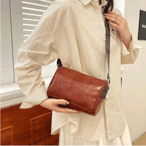 A person is wearing the Red Ruffle Wrist & Neck Blouse with Blign Rose.