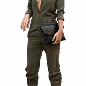 A woman wearing an olive green jumpsuit with a deep V neckline, holding a black clutch, and wearing black strappy heels.