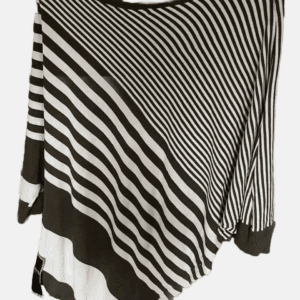 Loose-fitting, long-sleeved top with black and white diagonal, horizontal, and vertical stripes, asymmetrical hem, and wide neckline.