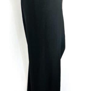 A pair of 6 Button Pocket Dress Pants in black hangs on a black hanger against a white background.