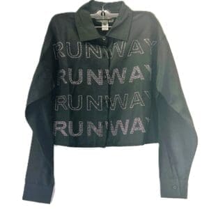 The Long Sleeve Cropped Runway Button Down is a black jacket with a collar and long sleeves, showcasing "RUNWAY" in large rhinestone-studded letters repeated four times on the front.