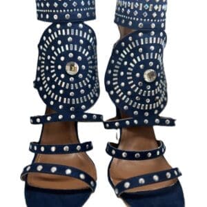 The Denim Bling Strap Back Zipper Heels are blue open-toe sandals featuring multiple straps and circular silver stud embellishments on the front and ankle cuffs.