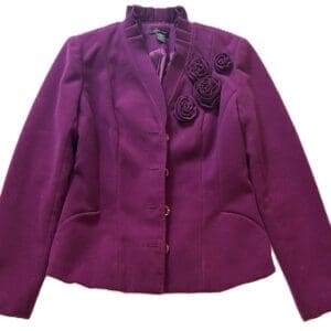 The Off the Shoulder Be Bold Top, featuring long sleeves, button closure, and three fabric rosettes on the left shoulder, is shown in purple against a white background.