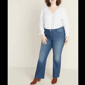 A person wearing a white blouse and 6 Button Pocket Dress Pants stands against a neutral background.
