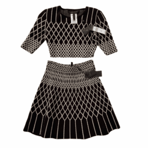 The 2PC Sweater Skirt Set is a black two-piece with a white geometric diamond pattern, including a short-sleeve crop top and matching flared skirt. Both items have tags attached.