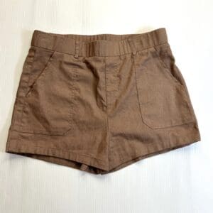 Brown Shorts with a high-waisted fit and front pockets, displayed flat on a white background.