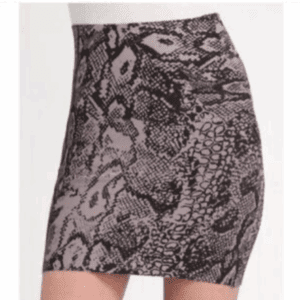 A close-up side view of a person wearing the Simone Body Con Skirt, a high-waisted, fitted mini skirt with a black and gray snake print pattern.