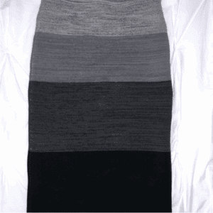 The Simone Body Con Skirt with horizontal grey and black bands is laid flat on a white, slightly wrinkled background.