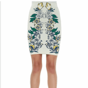 A woman wearing the Simone Body Con Skirt, a white high-waisted pencil skirt featuring a symmetrical green, yellow, and blue floral and leaf print.