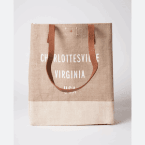 The Burlap Tote Bag features tan leather handles and has "Charlottesville Virginia USA" in white text printed on the front.