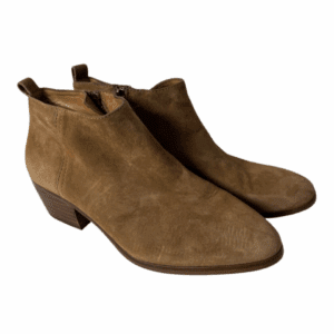 The Suede Ankle Bootie features tan suede, low stacked heels, and side zippers, shown on a white background.