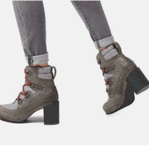 Wearing Sonoma 2 Tone Heeled Boot with red laces and light gray socks, styled with gray rolled-up jeans, walking on a white background.