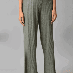 A person wearing a Faux Leather Belt, ribbed olive green knit pants, a beige top, and gray sandals stands against a plain gray background.