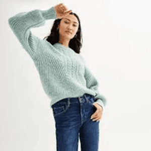 A person wearing the 2 PC Off the Shoulder Top and Pants Set in light blue stands against a plain white background, raising one arm near their head.