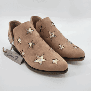 A pair of Womeen Austin Faux Leather Slip-Ons, in pink with metallic gold star cut-outs, are shown on a white background with a tag attached.