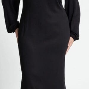 Model wears the Long Sleeve Long Cut Out Neck Dress, featuring long sleeves and three cut-out details at the upper chest and shoulders, set against a plain background.