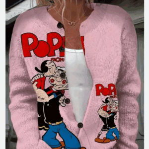 A woman wears Popeye's Button up Sweater, a light pink cardigan with cartoon prints of Popeye and Bluto, layered over a white top.