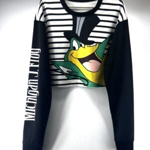 A long-sleeve crop top with black sleeves, white and black stripes on the body, a cartoon frog in a top hat on the front, and "Michigan J. Frog" printed on the left sleeve.