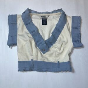 A Short Sleeve Denim & White Crop Top (Size S) with a collar, v-neck, frayed edges, and a front button is displayed flat on a white surface.