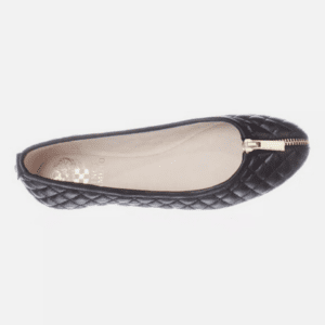 A black quilted ballet flat shoe with a gold zipper detail on the toe, shown from a top-down view.