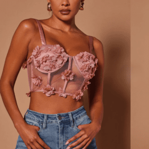 A woman in high-waisted blue jeans and the Chloe Corset Top SIZE S stands against a plain brown background.