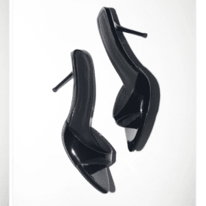 The Cult of Coquette Black Zena Patent Vegan Mules, size 10, are high-heeled black open-toe mule shoes with slim heels, shown against a plain white background.