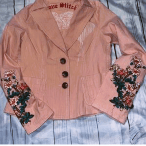 Love Stitch Flower Sleeve Jacket SIZE L in light pink with three dark buttons, wide lapels, and floral embroidery on both sleeves, displayed on a light wooden surface.