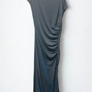 A dark gray, short-sleeve, ankle-length dress with gathered ruching on one side, displayed on a hanger against a plain white background.